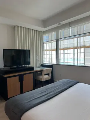 a bedroom with a bed and a desk with a television at Brickell-AKA Free Parking by Palermo Home Miami in Miami