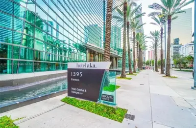 a sign in front of a building with palm trees at Brickell-AKA Free Parking by Palermo Home Miami in Miami