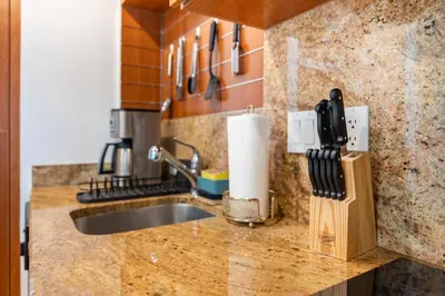 a kitchen counter with a sink and a knife block at Brickell AKA 32th Free Parking by Palermo Home Miami in Miami