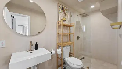 a bathroom with a sink and a mirror and a toilet at Luxury Miami Waterfront Retreat with Private Dock in Golden Glades