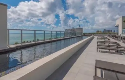 a swimming pool on top of a building with the ocean at Ocean Dream at Costa Hollywood in Hollywood