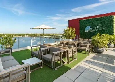 a patio with chairs and an umbrella on a roof at Ocean Dream at Costa Hollywood in Hollywood