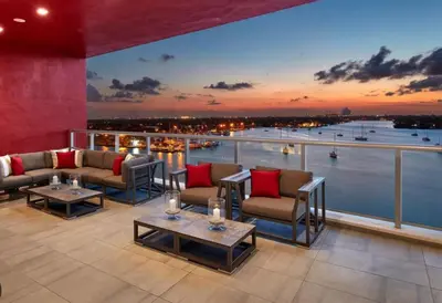 a balcony with couches and tables and a view of the water at Ocean Dream at Costa Hollywood in Hollywood