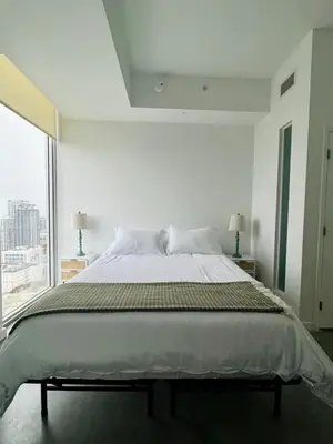 a bedroom with a large bed and a large window at Elevated Elegance Luxe View Pool Free Parking in Miami