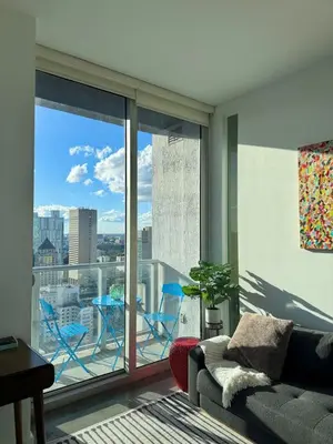 a living room with a couch and a large window at Elevated Elegance Luxe View Pool Free Parking in Miami