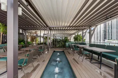 a restaurant with tables and chairs and a swimming pool at Luxury Studio with Stunning City Views in Miami