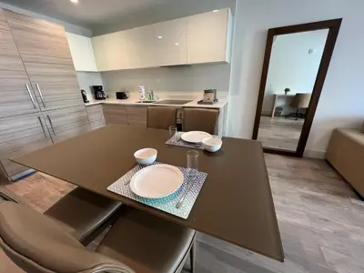 a kitchen with a table with two plates on it at A Fantastic apart with balcony and partial view of the beach 4 Px in Hollywood