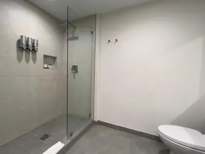 a bathroom with a glass shower and a toilet at A Fantastic apart with balcony and partial view of the beach 4 Px in Hollywood