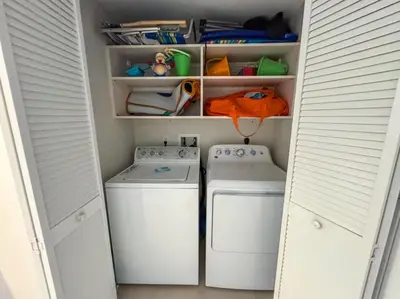 a laundry room with two washing machines in it at Luxury 3 bedroom condo with pool in Hallandale Beach
