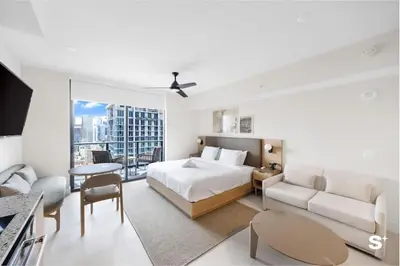 a bedroom with a bed and a living room with a couch at Modern Studio in Downtown Miami with Stunning City Views in Miami
