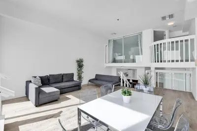 a living room with a couch and a table at Shine Suites Balcony Duplex 9 in Miami Beach