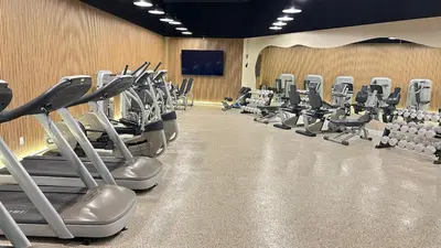 a gym with rows of exercise bikes and treadmills at Shine Suites Balcony Duplex 9 in Miami Beach