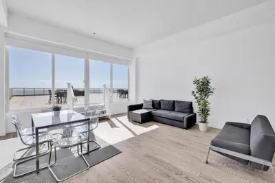 a living room with a table and a couch at Shine Suites Balcony Duplex 9 in Miami Beach