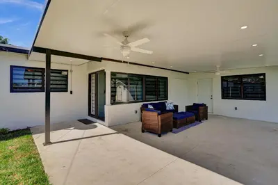 a living room with chairs and a ceiling fan at Luxe Haven Near Aventura in Ives Estates