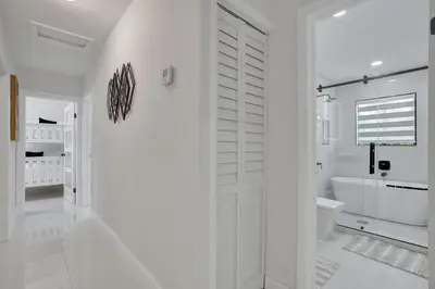 a white bathroom with a toilet and a sink at Luxe Haven Near Aventura in Ives Estates