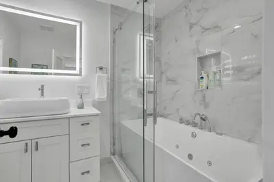 a white bathroom with a shower and a sink at Luxe Haven Near Aventura in Ives Estates