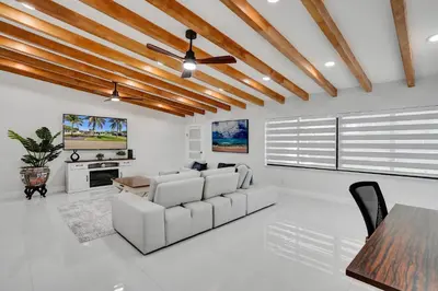 a living room with a white couch and a table at Luxe Haven Near Aventura in Ives Estates