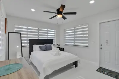 a bedroom with a bed and a ceiling fan at Serene Suite Near Aventura in Ives Estates