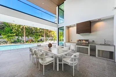an open kitchen and dining room with a table and chairs at Luxury 6-Bedroom Villa stunning 3-story estate in Golden Beach