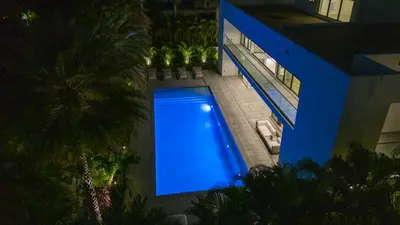 an overhead view of a blue swimming pool in a building at Luxury 6-Bedroom Villa stunning 3-story estate in Golden Beach