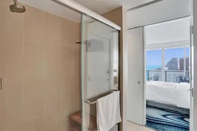 a bathroom with a shower with a glass door at Luxury Beachfront Two Bedroom Condo - W Residences in Fort Lauderdale