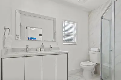 a white bathroom with a sink and a toilet at Pool, golf & 4 mi. from the beach & The Hard Rock in Hollywood