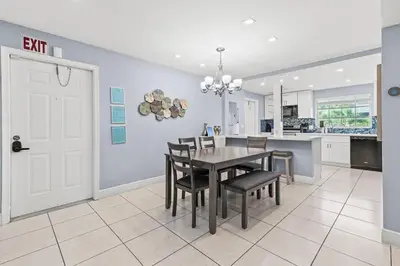 a kitchen and dining room with a table and chairs at Beach, Pool & Las Olas Getaway in Fort Lauderdale