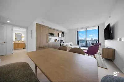 a kitchen and living room with a table and chairs at City Luxe Retreat Modern 2-BD with Water Views in Miami
