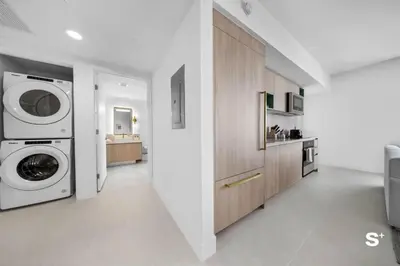 a white laundry room with a washer and dryer at City Luxe Retreat Modern 2-BD with Water Views in Miami