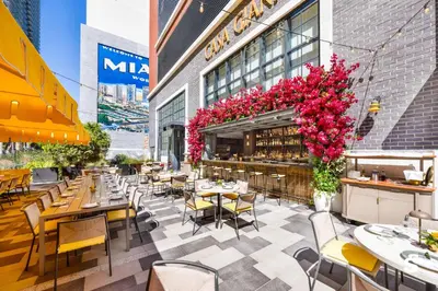 a restaurant with tables and chairs and red flowers at Studio in DTW Miami - City Views & Gym in Miami