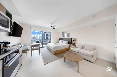 a large white room with a bed and a couch at Studio in DTW Miami - City Views & Gym in Miami