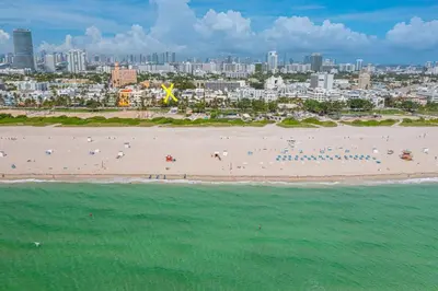 an aerial view of a beach with people in the water at One block from beach South Beach Ocean Dr-King Bed in Miami Beach