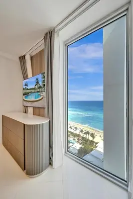 a room with a large window with a view of the ocean at Luxury Oceanfront 3 Bedroom condo on the beach 16 Floor in Hollywood