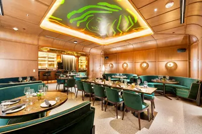 a dining room with tables and green chairs at From 43th Floor a Luxury Condo Awaits For You! in Miami