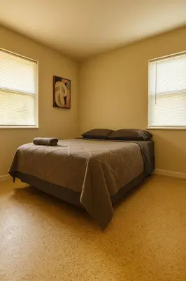 a bed in a room with two windows at The Awali in Miami