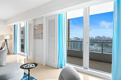 a living room with large windows and a view of the city at Ritz-Carlton Luxury Oceanfront 2BR on 16th Floor in Fort Lauderdale