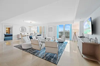 a living room with white furniture on a rug at Ritz-Carlton Luxury Oceanfront 2BR on 16th Floor in Fort Lauderdale