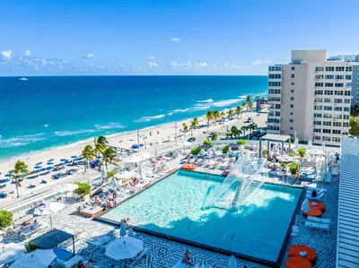 an overhead view of a swimming pool and a beach at 16th Floor Luxury 2 Bedroom - Ocean Views & Luxury in Fort Lauderdale