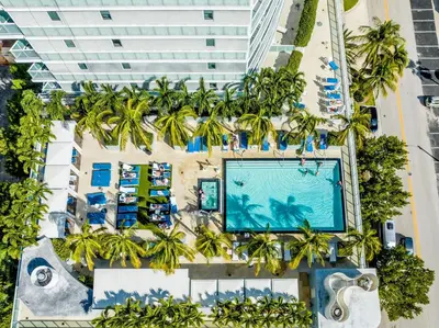 an overhead view of a hotel with a pool and palm trees at 16th Floor Luxury 2 Bedroom - Ocean Views & Luxury in Fort Lauderdale