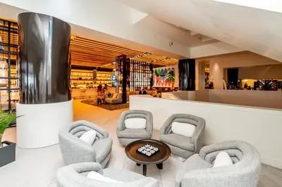 a lobby of a building with chairs and a table at W Residences 2 Bed Unit - Beachfront and Luxe Stay in Fort Lauderdale