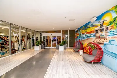 a store lobby with chairs and a mural at W Residences 2 Bed Unit - Beachfront and Luxe Stay in Fort Lauderdale