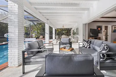 a living room with chairs and a pool at Tranquil Heirloom Hideaway Pool in South Miami in Miami