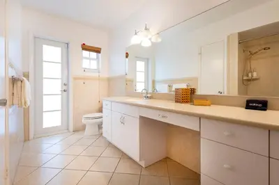 a bathroom with a sink and a toilet and a mirror at Tranquil Heirloom Hideaway Pool in South Miami in Miami