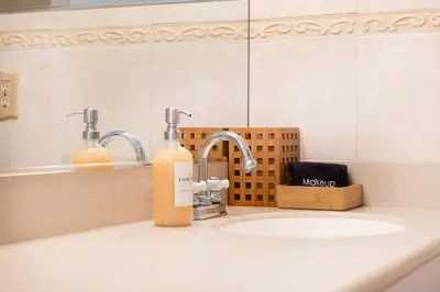 a sink with a bottle of soap and a soap dispenser at Tranquil Heirloom Hideaway Pool in South Miami in Miami