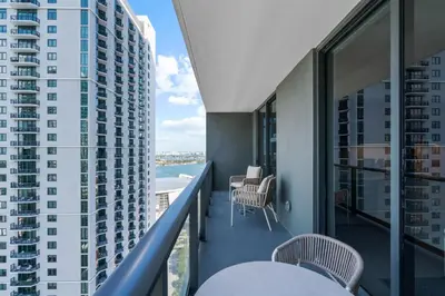 a balcony with chairs and a view of the ocean at Luxury 2-Bdrm Condo in the Heart of Downtown Miami in Miami