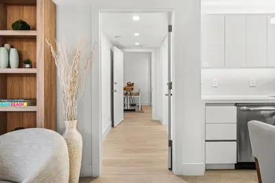 a living room with a vase and a kitchen at 1 Bedroom Private Residence at Roney Palace -1129 in Miami Beach