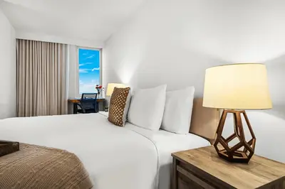 a hotel room with a bed and a lamp at 2 Bedroom Private Residence at Roney Palace -11289 in Miami Beach