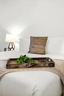 a tray on a bed with a plant on it at 2 Bedroom Private Residence at Roney Palace -11289 in Miami Beach