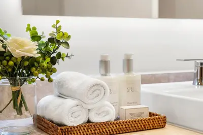 a basket of towels and a vase of flowers in a bathroom at 2 Bedroom Private Residence at Roney Palace -11289 in Miami Beach