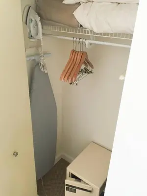 a room with a closet with a bed and a shelf at Cocktails & Coffee with bay & city view balconies in Miami